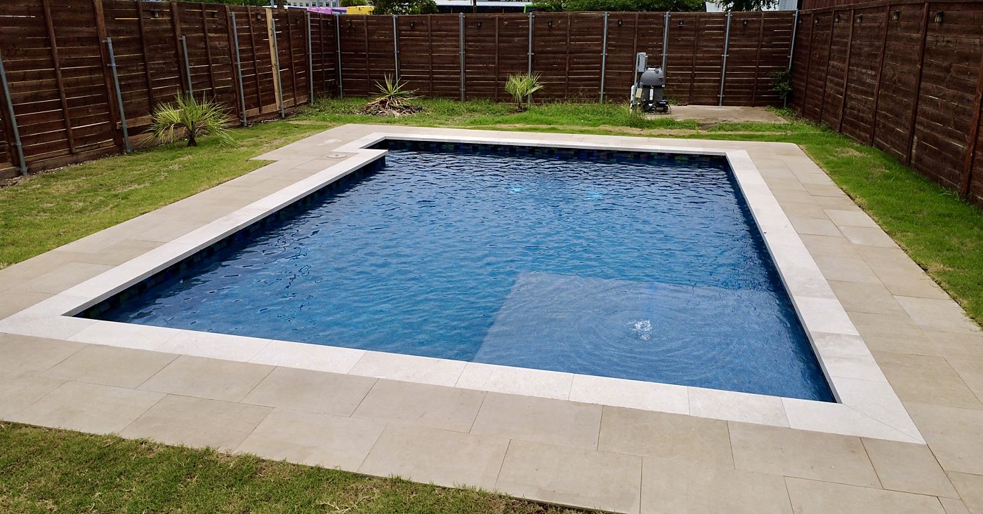 Pool with tanning ledge, stone coping and decking